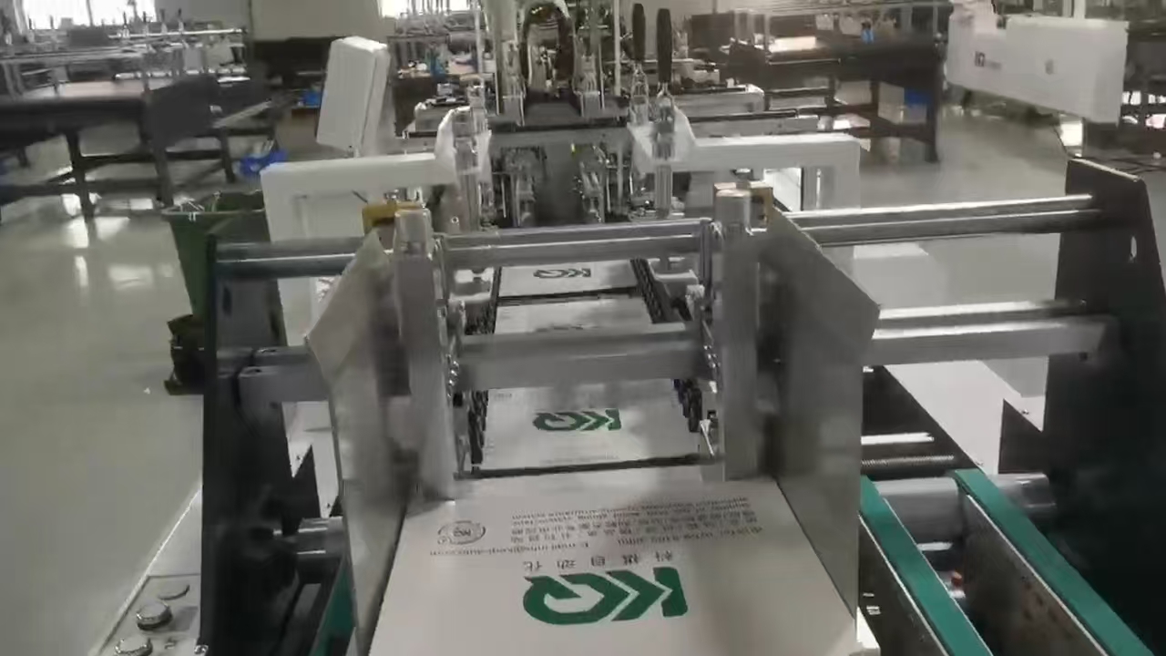 Printed carton feeding into automatic tape application machine