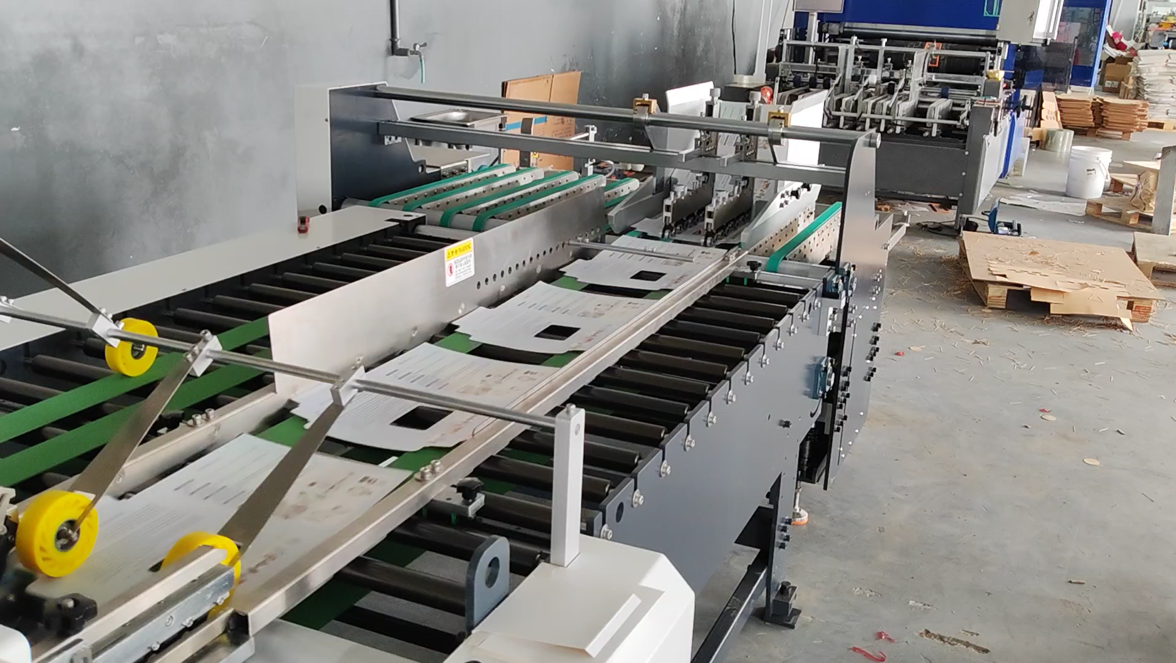 Automatic tape application system for envelope mailer production