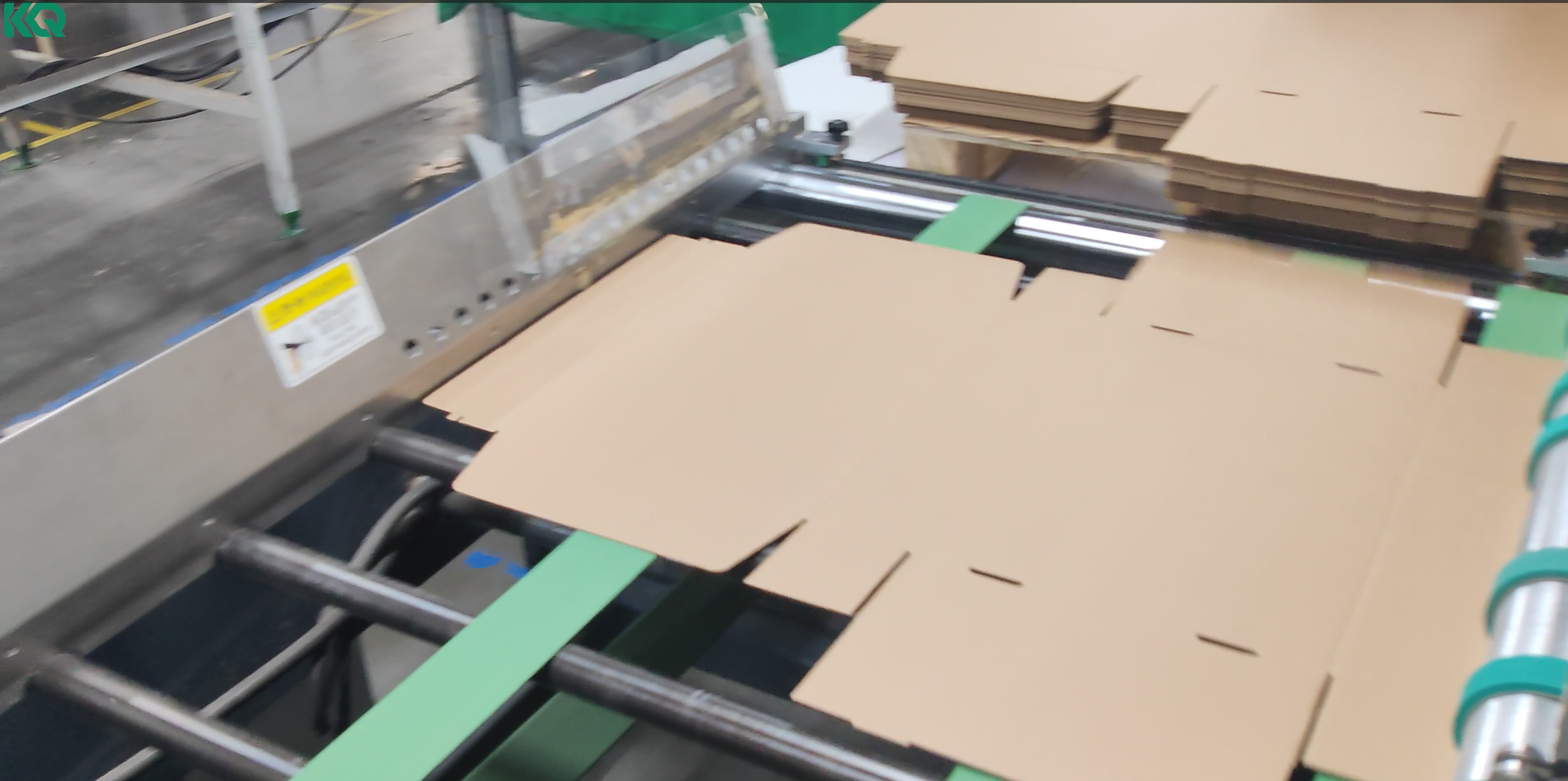 Carton feeding into automatic tape application system