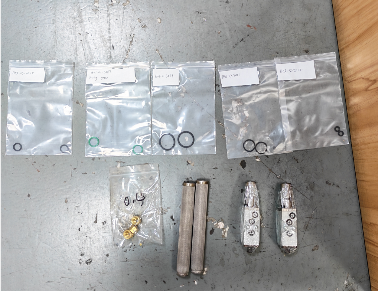 Hot melt adhesive spare parts including nozzles, filters, seals and maintenance components